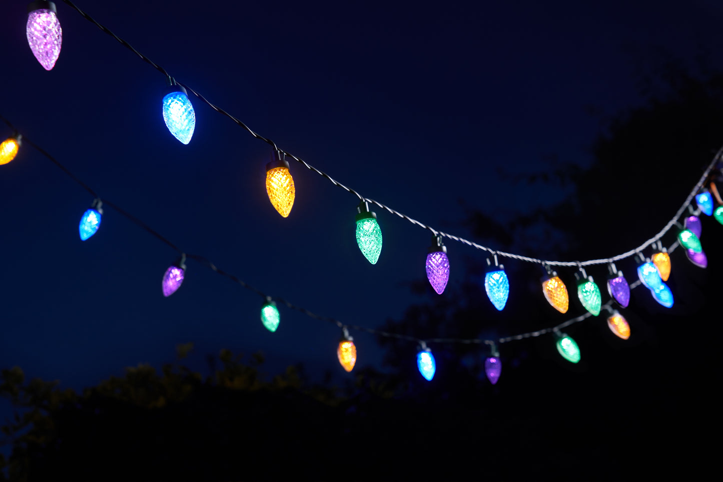 String of colorful lights against a dark sky