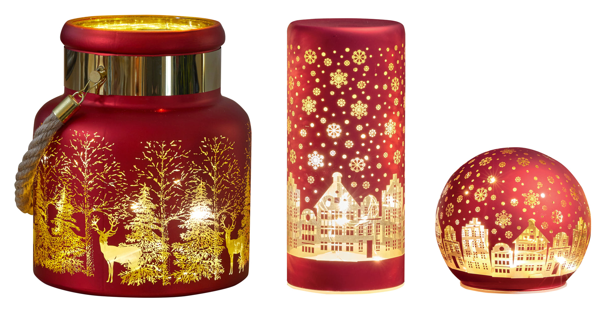 Set of three red candle holders with gold winter scene designs on a white background