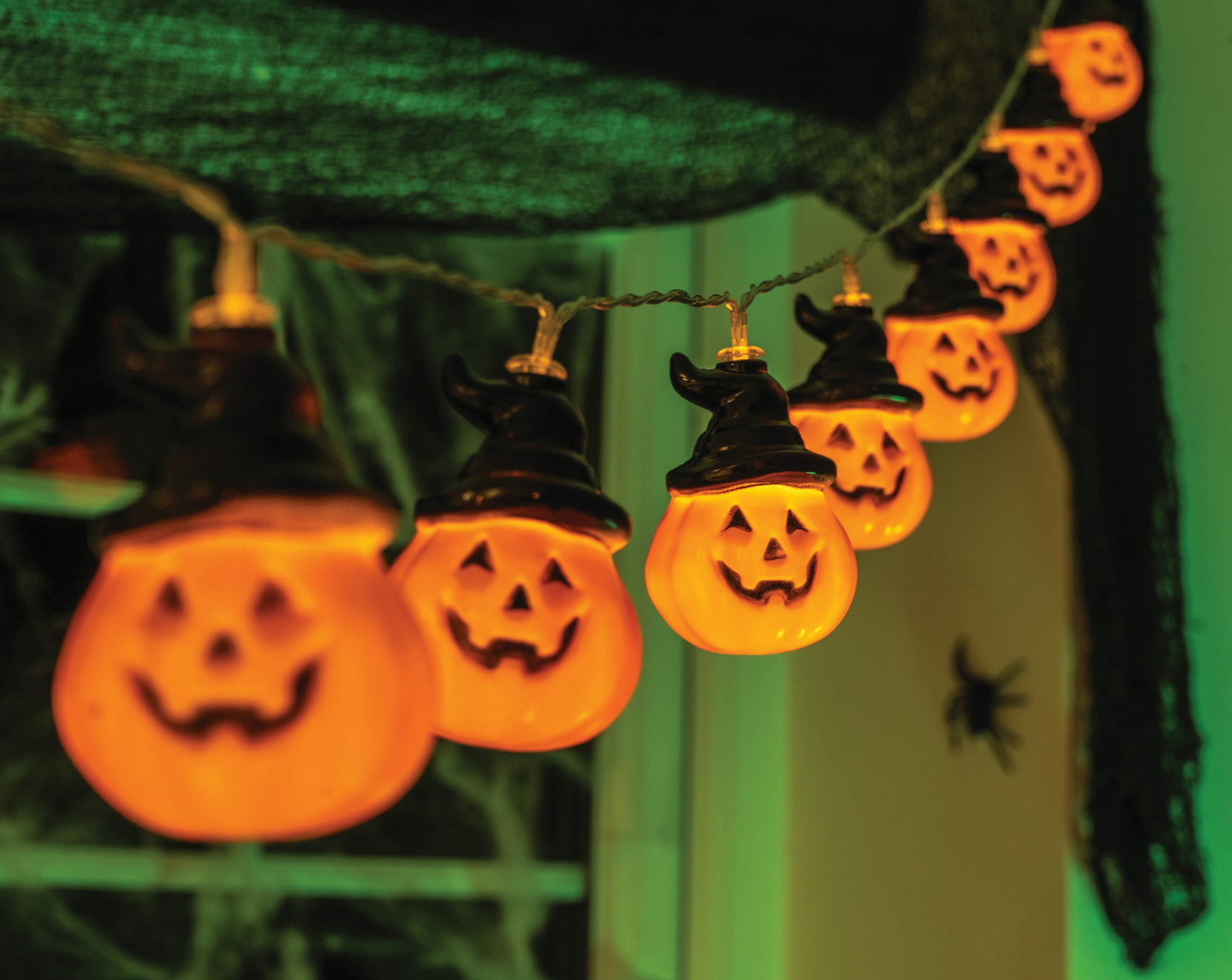 Halloween-themed string lights with jack-o'-lantern design on a dark background