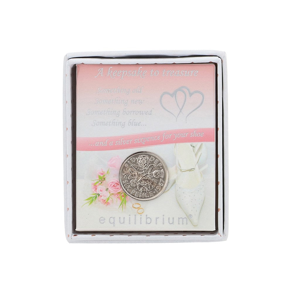 Decorative coin in a box with floral design and text