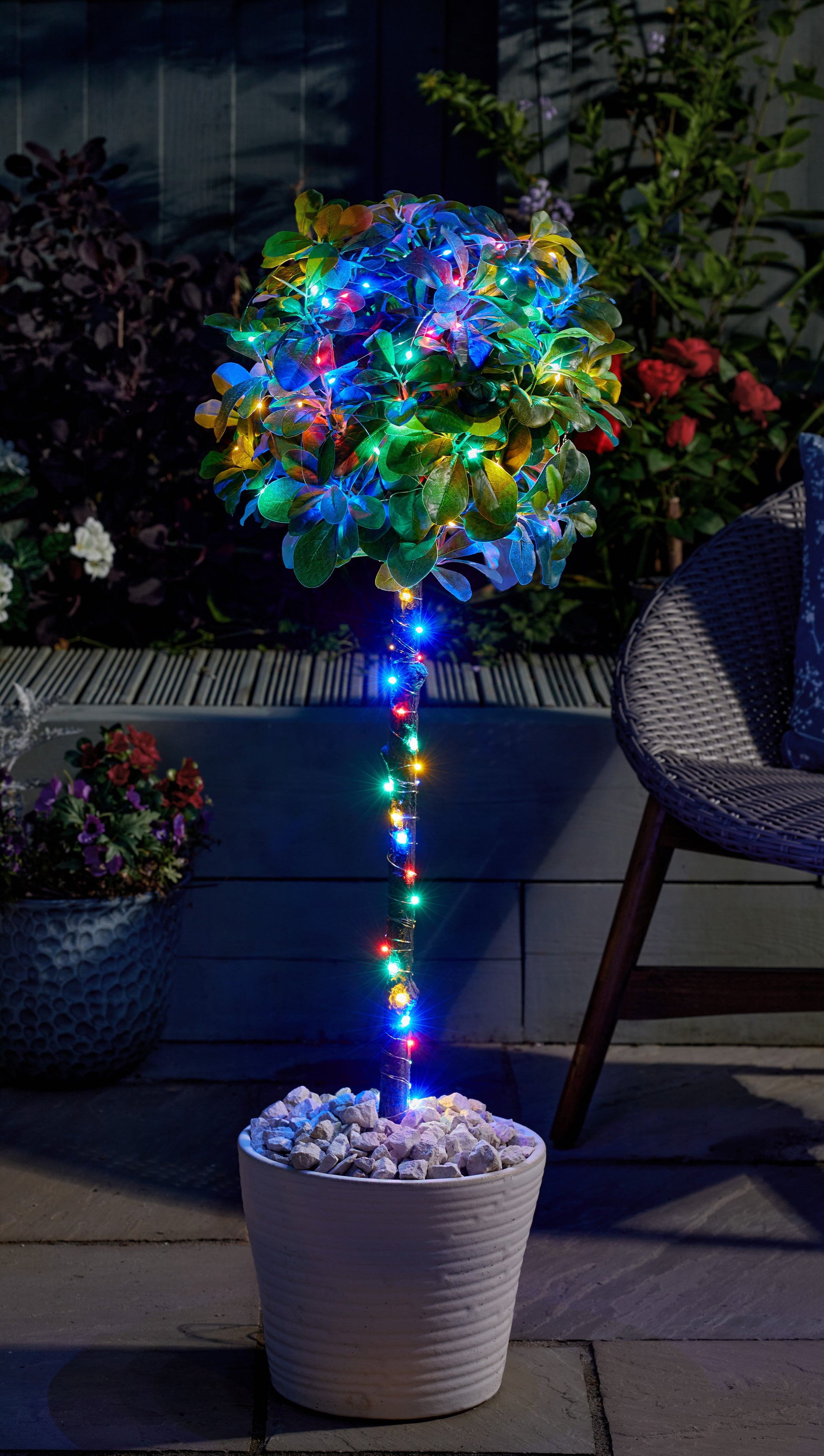 Decorative plant with colorful lights in a pot on a patio