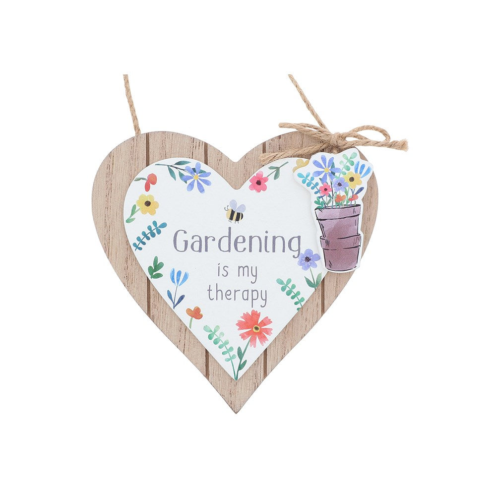 Heart-shaped wooden sign with floral designs and 'Gardening is my therapy' text on a white background