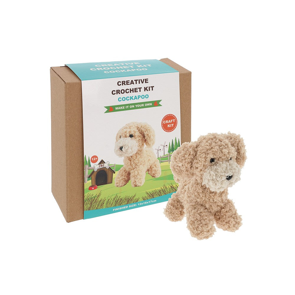 Crochet kit for creating a Cockapoo toy with packaging on a white background