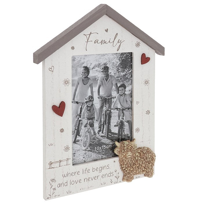 Decorative photo frame shaped like a house with a family picture and text on a white background