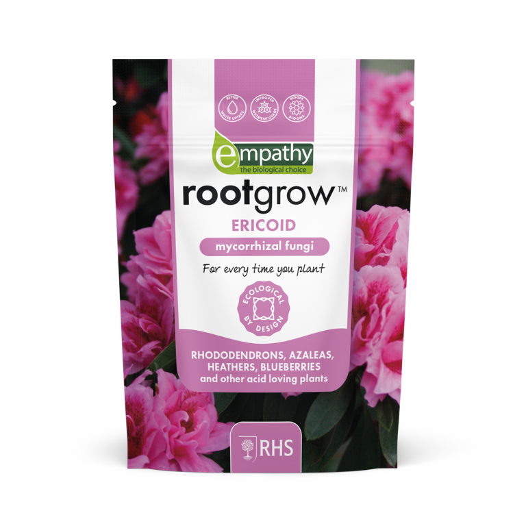 Rootgrow mycorrhizal fungi package with pink flowers in the background