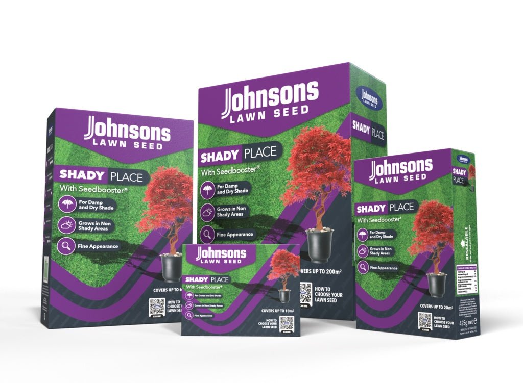 Three boxes of Johnsons Lawn Seed for shady places on a white background