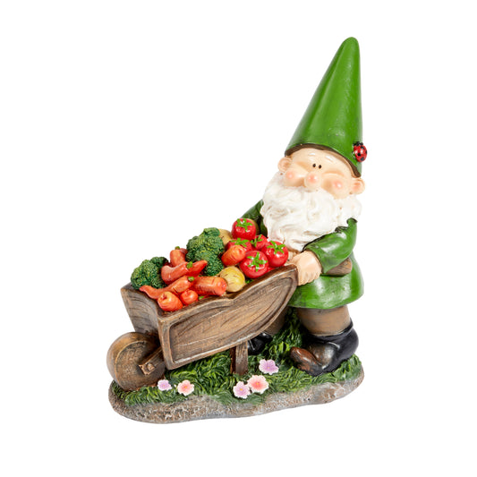 Gnome figurine with a wheelbarrow full of vegetables on a white background