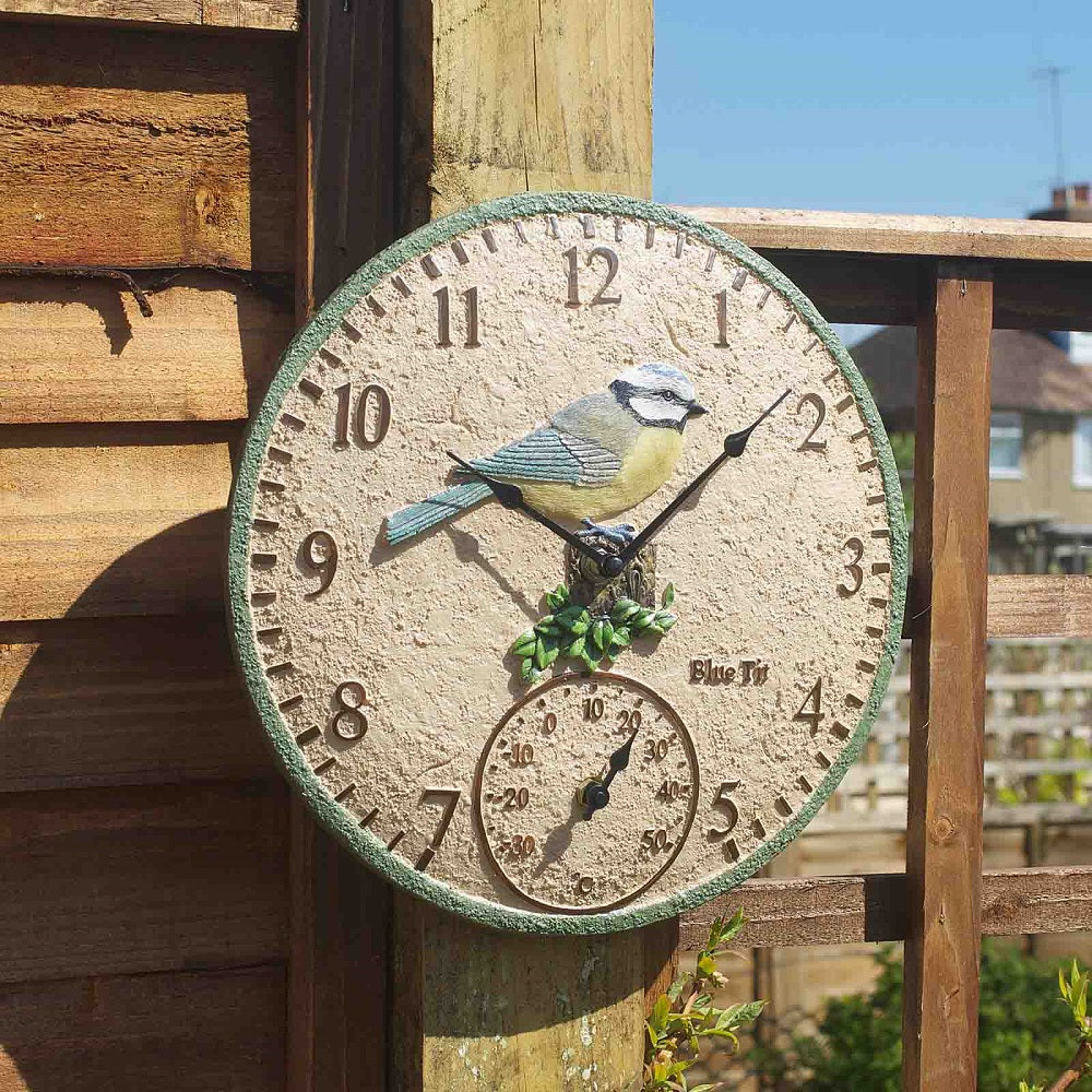 Decorative outdoor clock with bird design on a wooden post