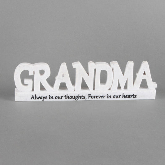 White wooden sign with 'GRANDMA' and text on a gray background
