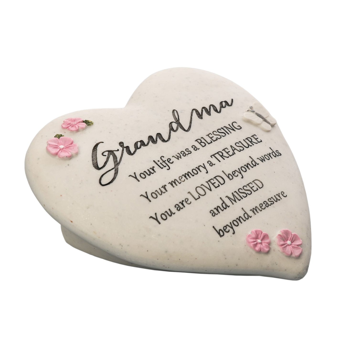 Heart-shaped stone with engraved message and pink flowers on a white background