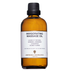 Bottle of invigorating massage oil with a white label on a white background