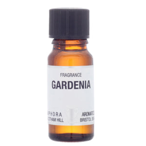 Amber glass bottle of Gardenia fragrance with a black cap on a white background