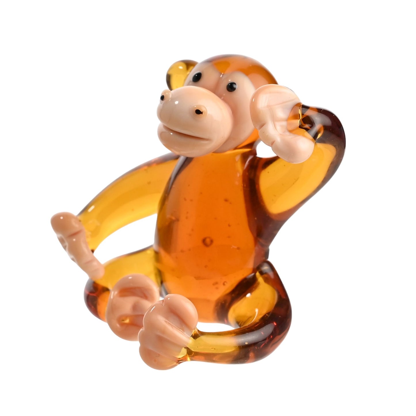 Glass monkey figurine on a white background