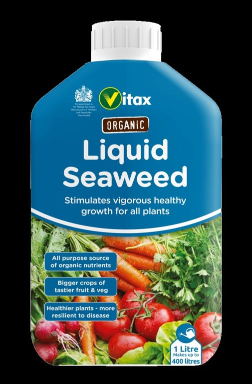 Vitax Organic Liquid Seaweed fertilizer bottle with vegetables on a black background