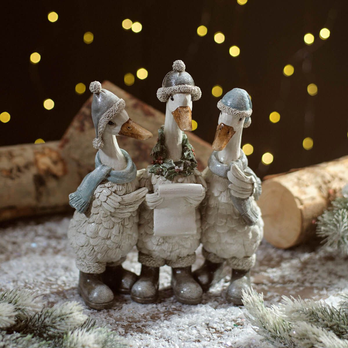 Christmas Carolling Goose Figure Trio | Resin decoration of three geese wearing knitted hats, scarves, and boots, holding a song sheet UK