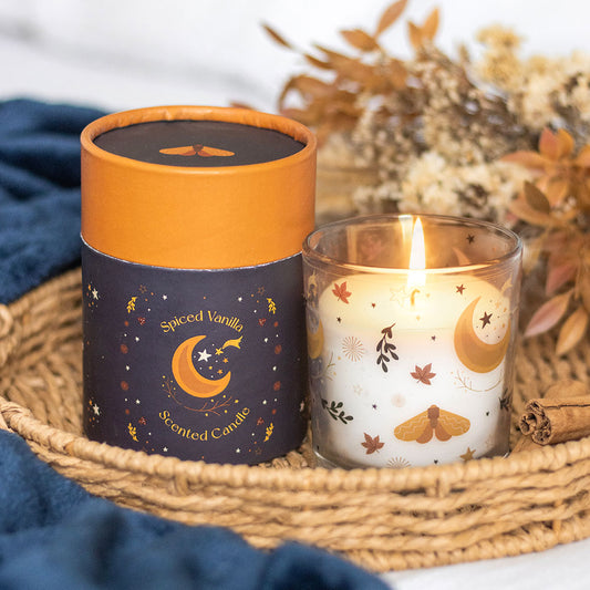 Spiced Vanilla scented candle with decorative packaging on a woven tray.