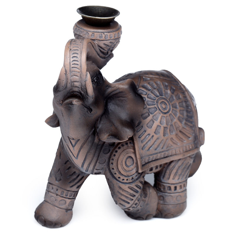 Decorative elephant statue with a candle holder on a white background