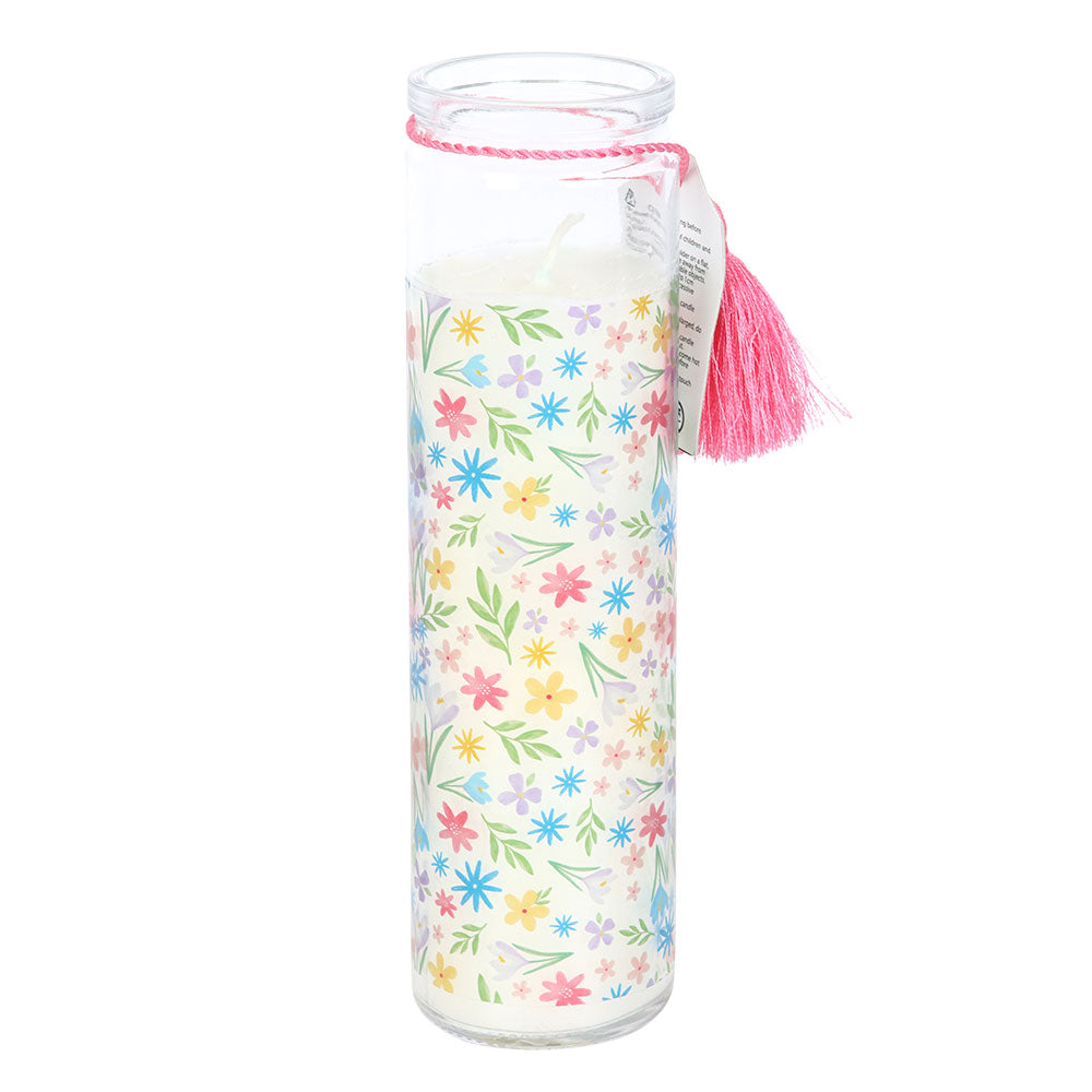 Clear glass jar with floral pattern and pink tassel on a white background