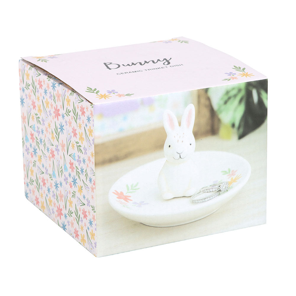 Decorative rabbit figurine on a stand with floral packaging