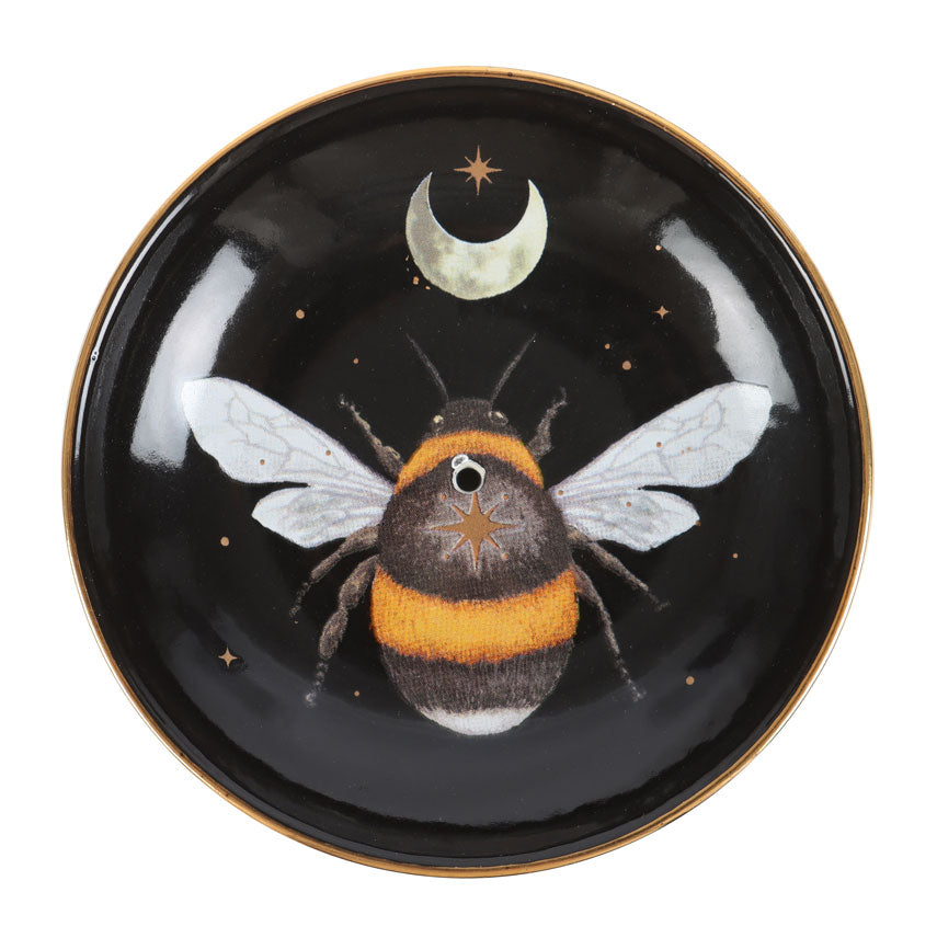 Decorative plate with a bee and moon design on a black background