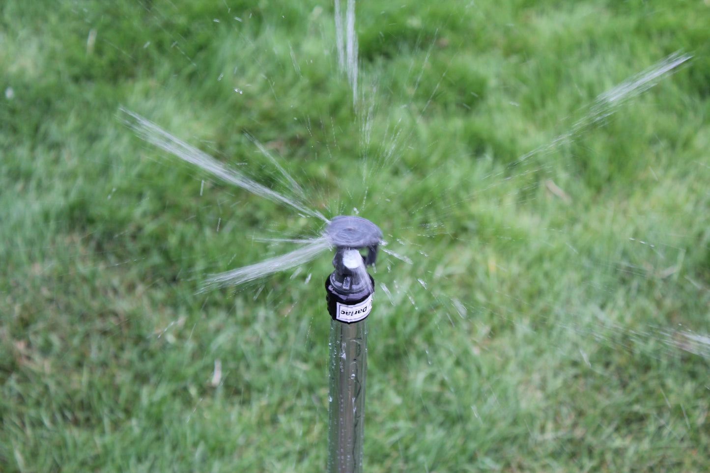 Sprinkler spraying water on a grassy area