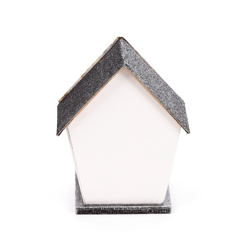 A small house-shaped decorative object with a white front and a glittery dark gray roof and base, photographed on a plain white background.
