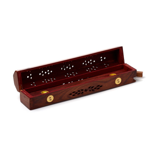 Wooden incense holder with decorative patterns on a white background