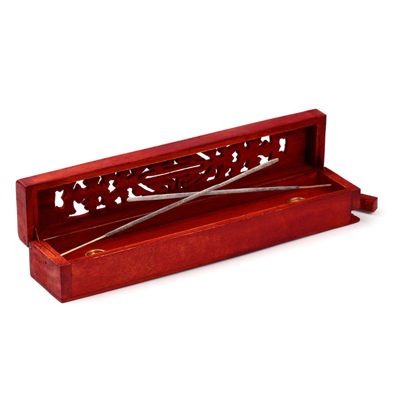 Red incense holder with silver incense sticks on a white background