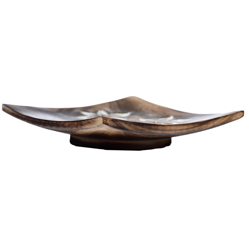 Wooden bowl with metallic interior on a white background