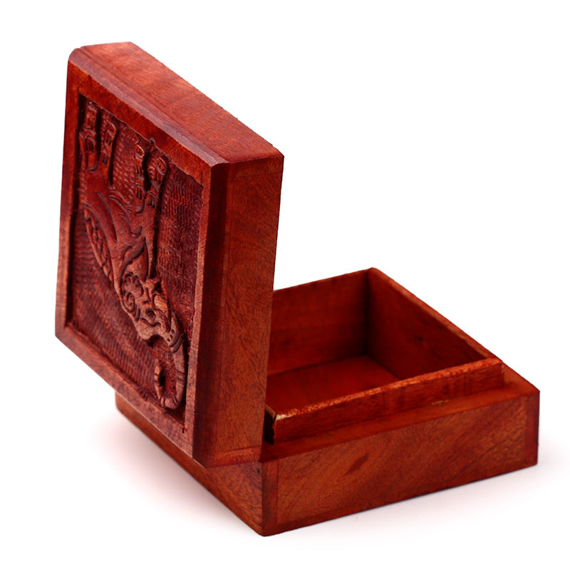 Wooden box with intricate carvings on a white background