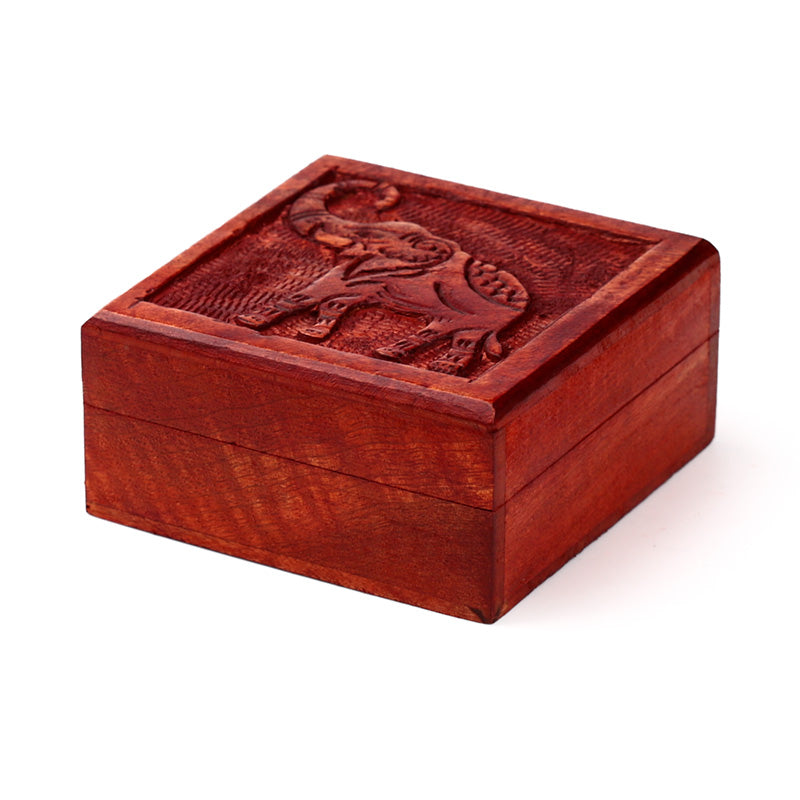 Wooden box with an embossed elephant design on a white background