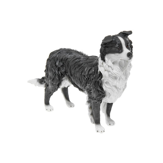 Dog figurine with black, white, and gray fur on a white background