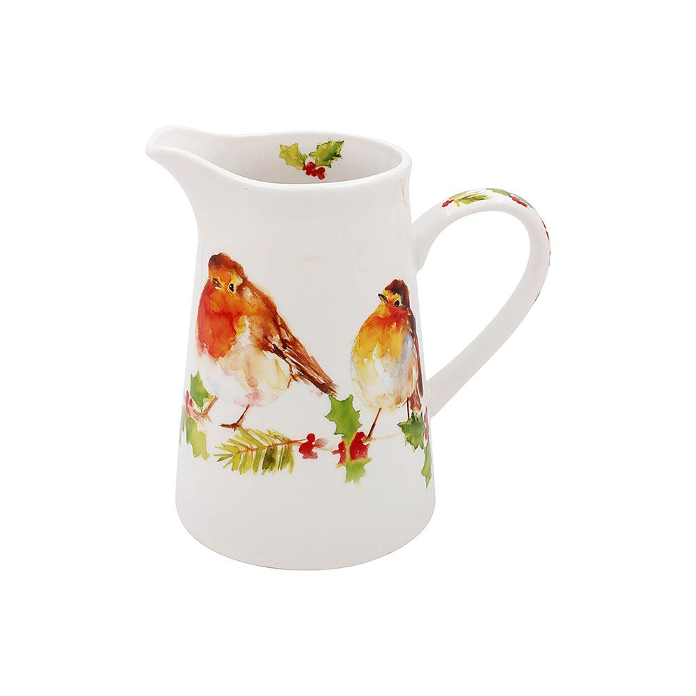 White ceramic pitcher with robin and holly design on a white background