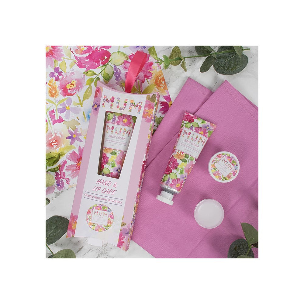 Floral-themed hand and lip care set with packaging on a floral background
