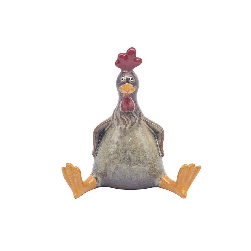 Ceramic chicken figurine with a red comb on a white background