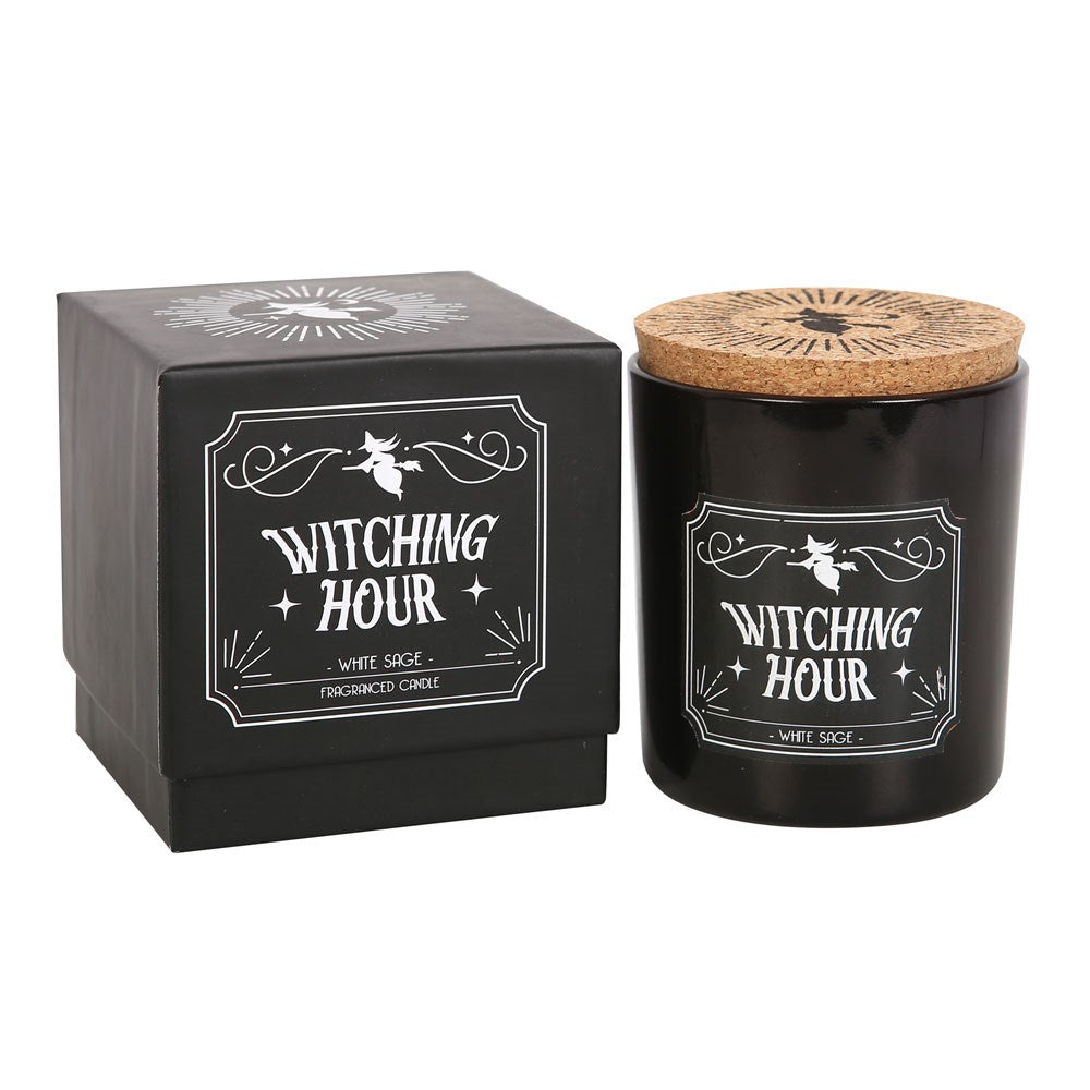 Black candle labeled 'Witching Hour' with a cork lid next to its packaging on a white background.