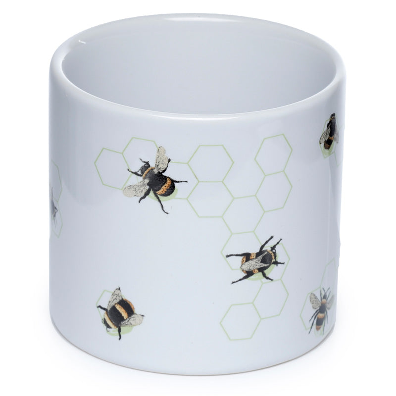 White mug with bee and honeycomb pattern on a white background