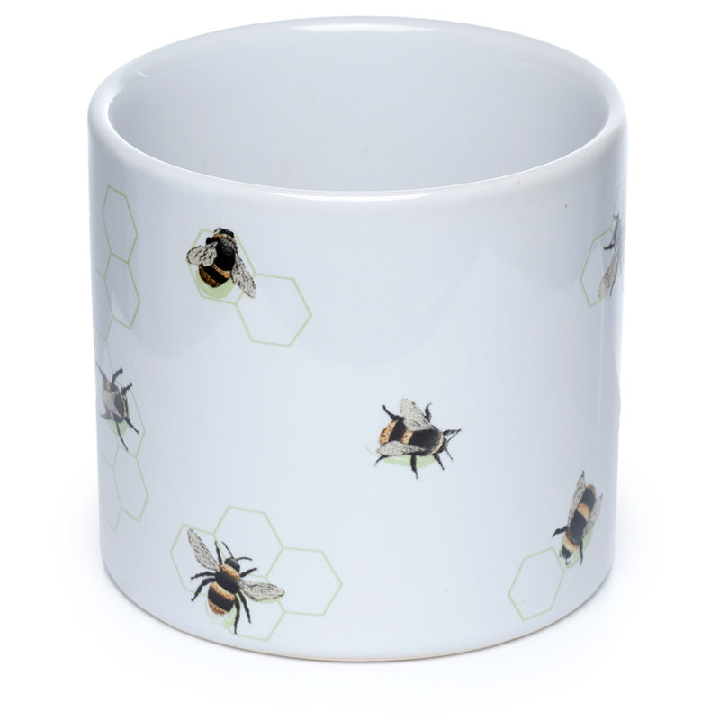 White mug with bee and hexagon pattern on a white background