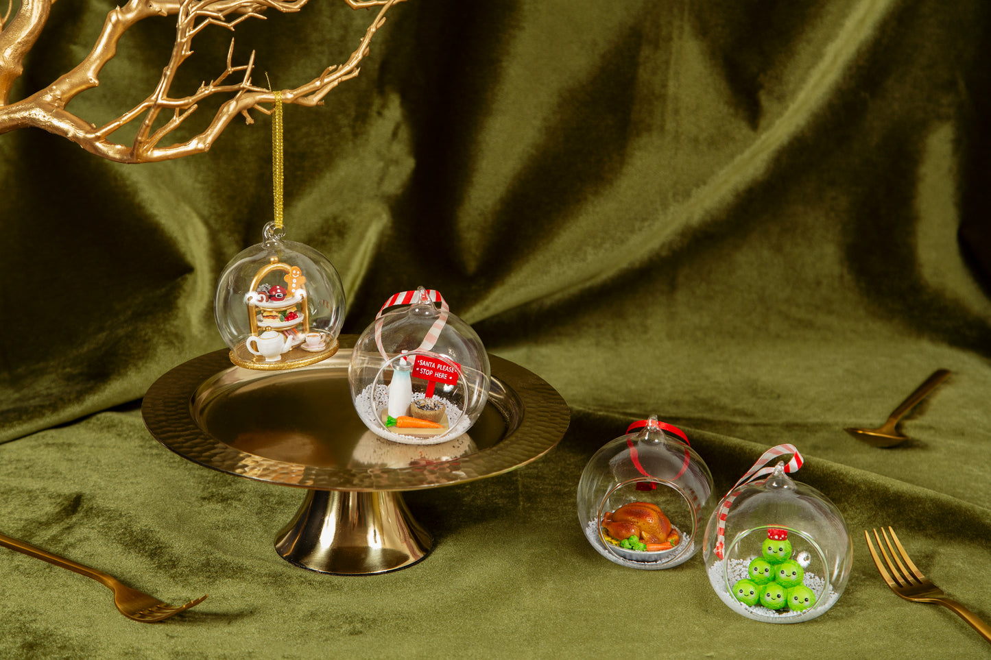 Decorative Christmas ornaments in glass spheres on a green fabric background