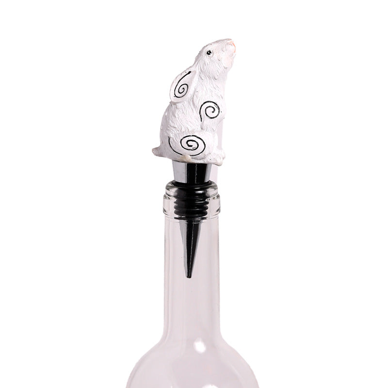 Decorative bottle stopper with a white seal design on a white background