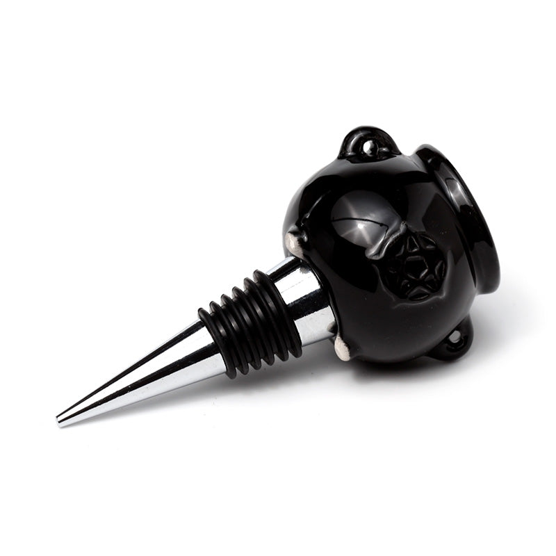 Black bottle stopper shaped like a pig on a white background