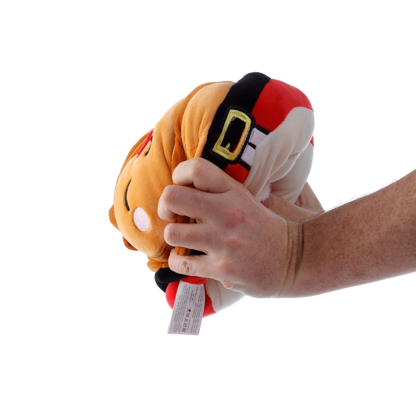Plush toy resembling a character with a hand holding it on a white background