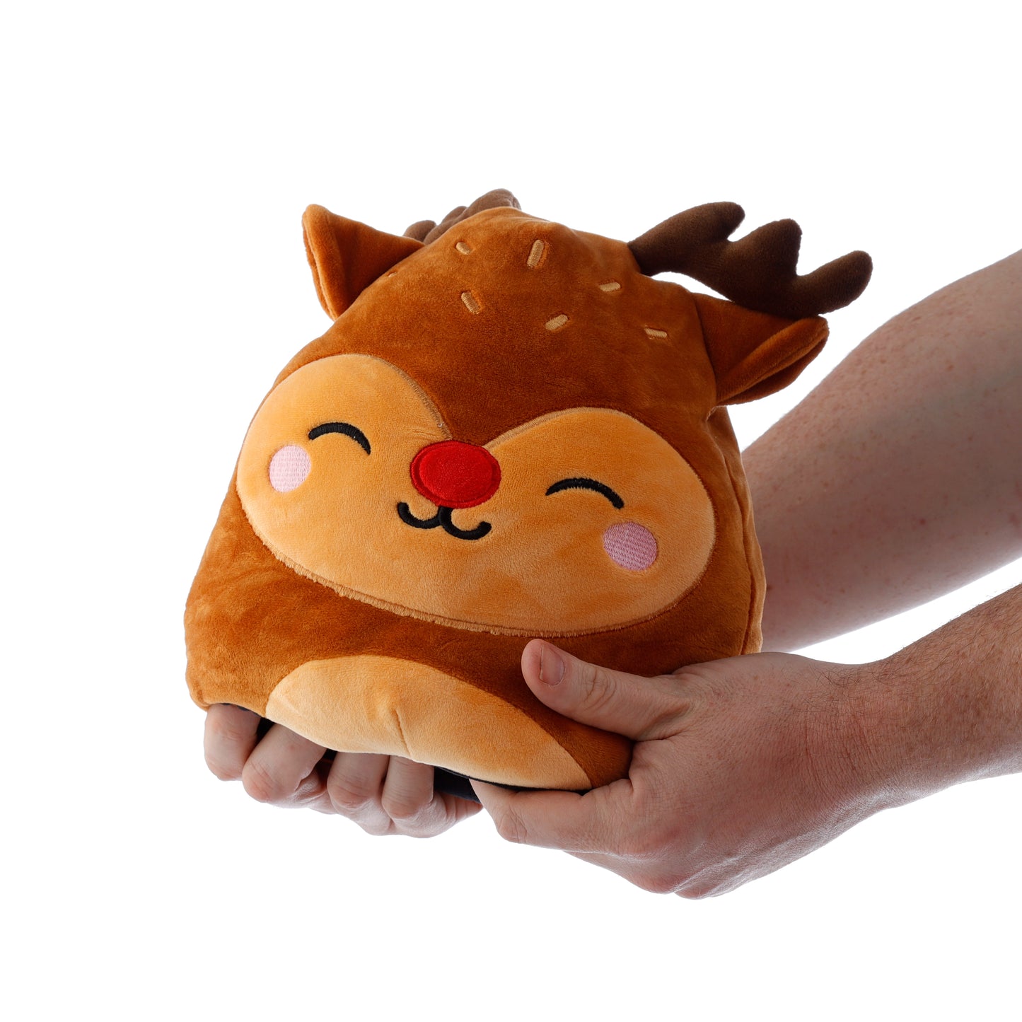 Plush reindeer toy held by a hand on a white background
