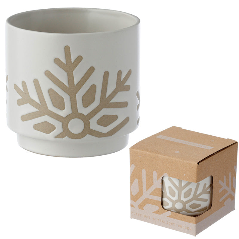 White ceramic planter with beige snowflake design next to its packaging box on a white background