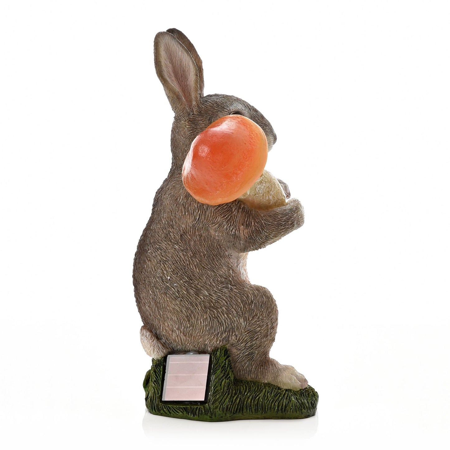 Statue of a rabbit with a carrot on a white background
