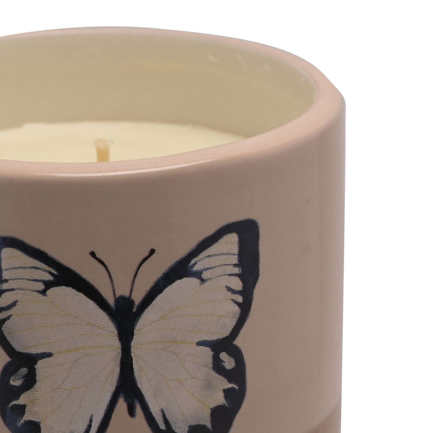 Candle in a ceramic holder with a butterfly design on a white background