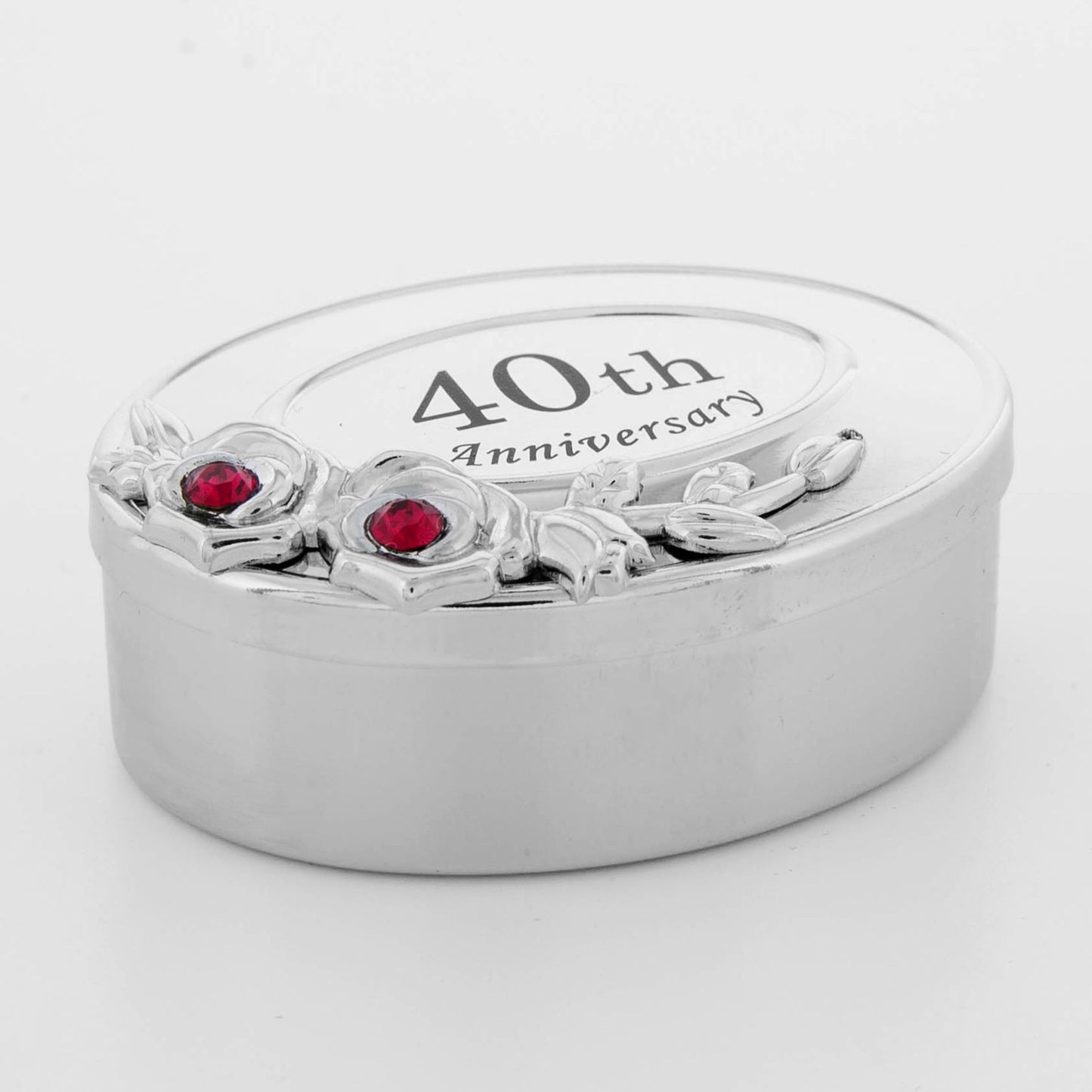 Silver ring box with '40th Anniversary' engraving and red gemstones on a white background
