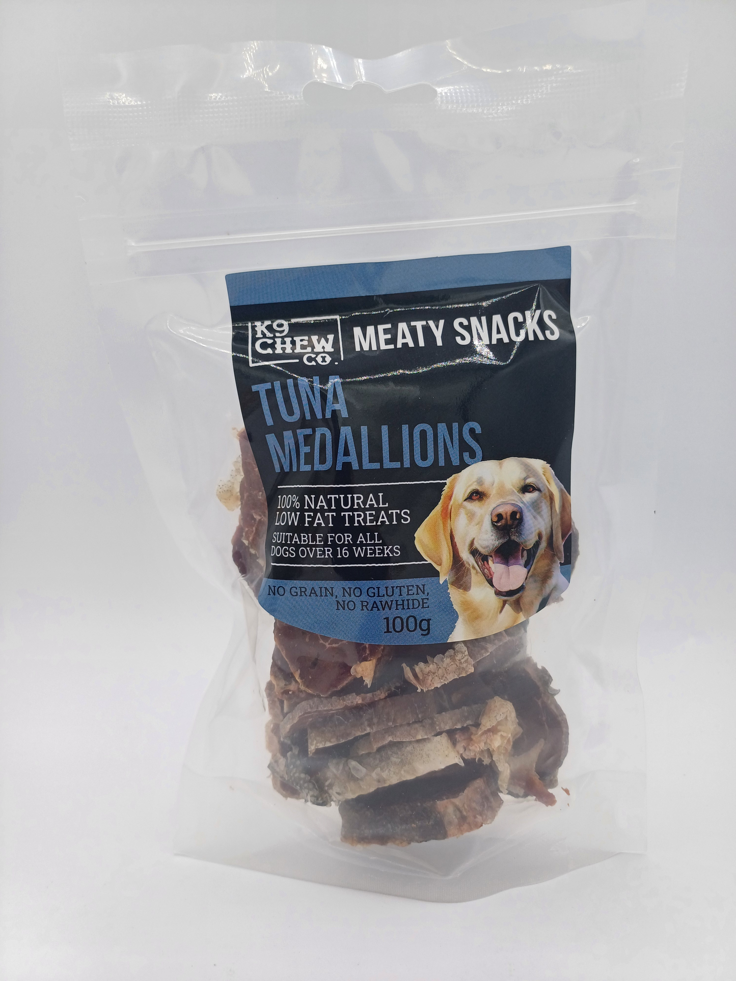 Packaged tuna medallions for dogs with a visible brand label on a white background