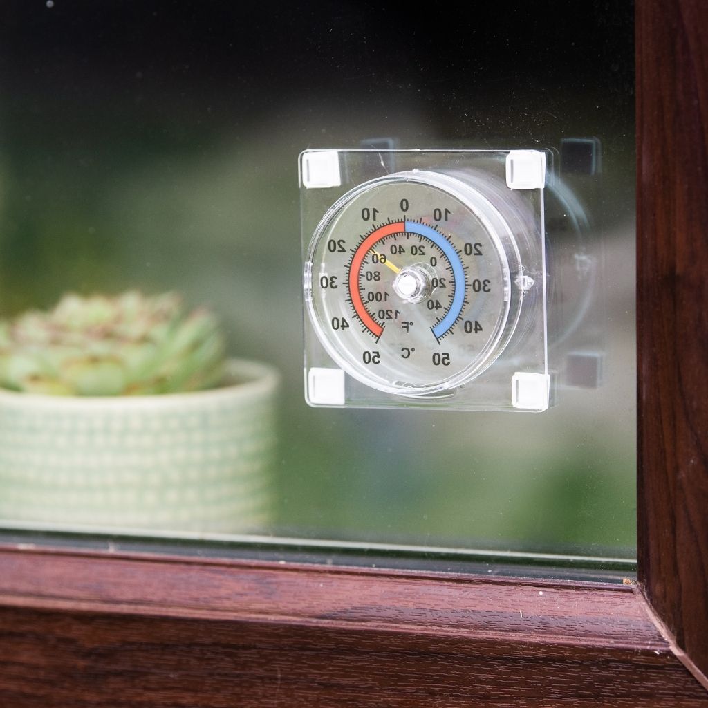 Thermometer on a window sill with a blurred background