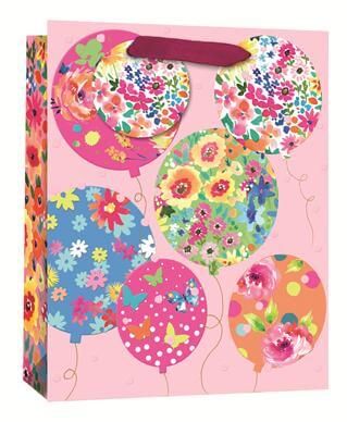 Gift bag with floral balloon design on a pink background